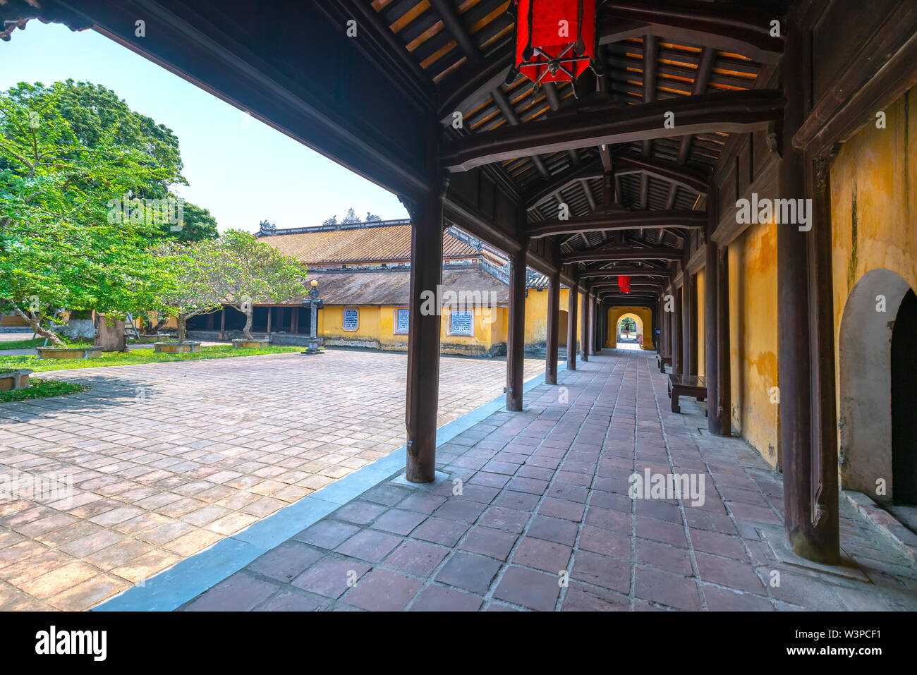 Amazing wooden hallway in the imperial Forbidden Citadel. The place that leads to the palaces of kings, feudal officials in the 19th century in Hue, V Stock Photo