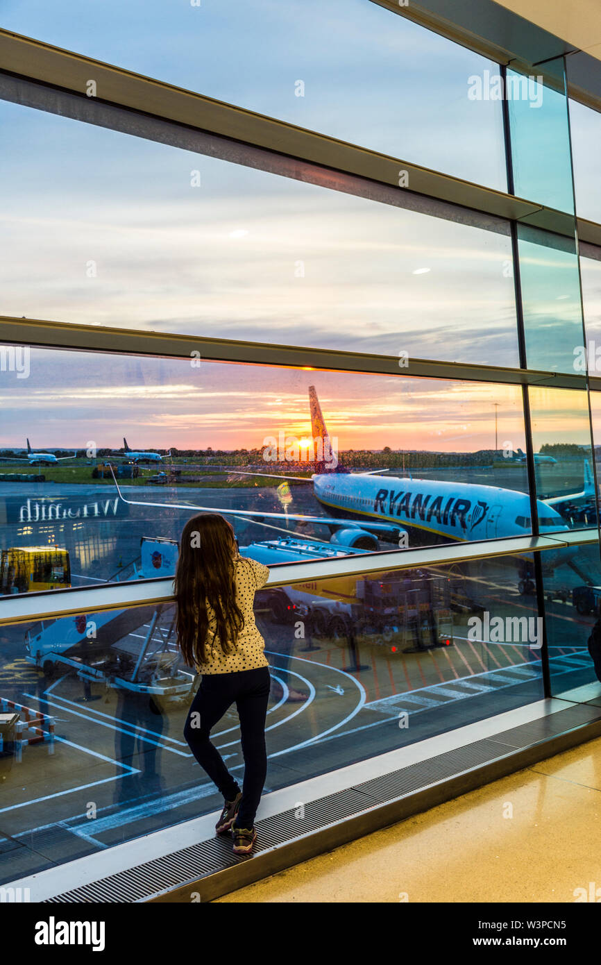 Dublin Airport, Terminal One, child, girl watches sunrise. Ireland