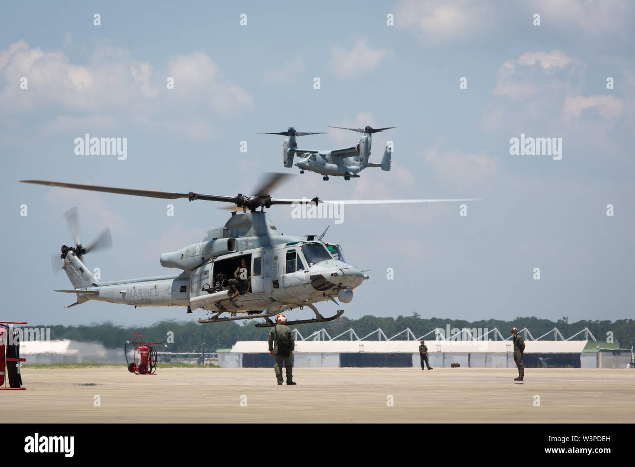 A U.S. Marine Corps UH-1Y Huey and MV-22 Osprey assigned to Marine Medium Tiltrotor Squadron (VMM) 264 prepare for landing during a homecoming reception at Marine Corps Air Station New River, North Carolina, July 14, 2019. Marines and Sailors with VMM-264 returned from a deployment with the 22nd Marine Expeditionary Unit. (U.S. Marine Corps photo by Cpl. Cody Rowe) Stock Photo