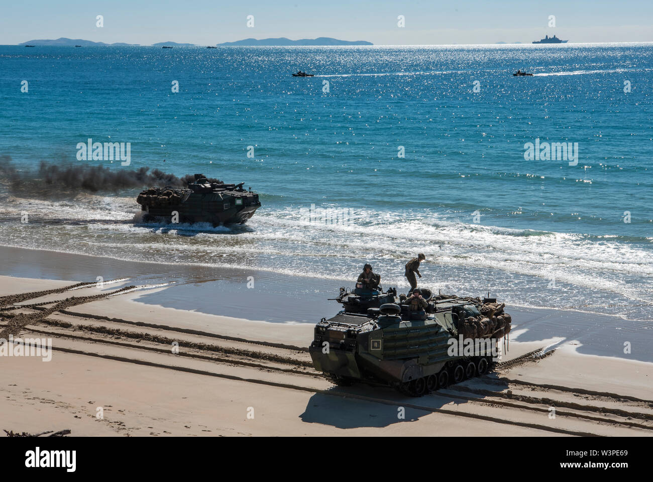 Queensland, Australia officials and military personnel of various nations toured multiple locations during exercise Talisman Sabre 2019 (TS19), July 16, 2019. During the tour, the officials and military personnel received the opportunity to ride in multiple military aircraft and vehicles, witness a TS19 amphibious landing exercise and view a military working dog demonstration. (U.S. Air Force photo by Senior Airman Ashley Maldonado) Stock Photo