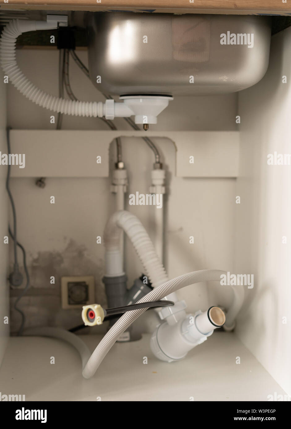 repair and decoration. water pipes in the kitchen under the sink Stock