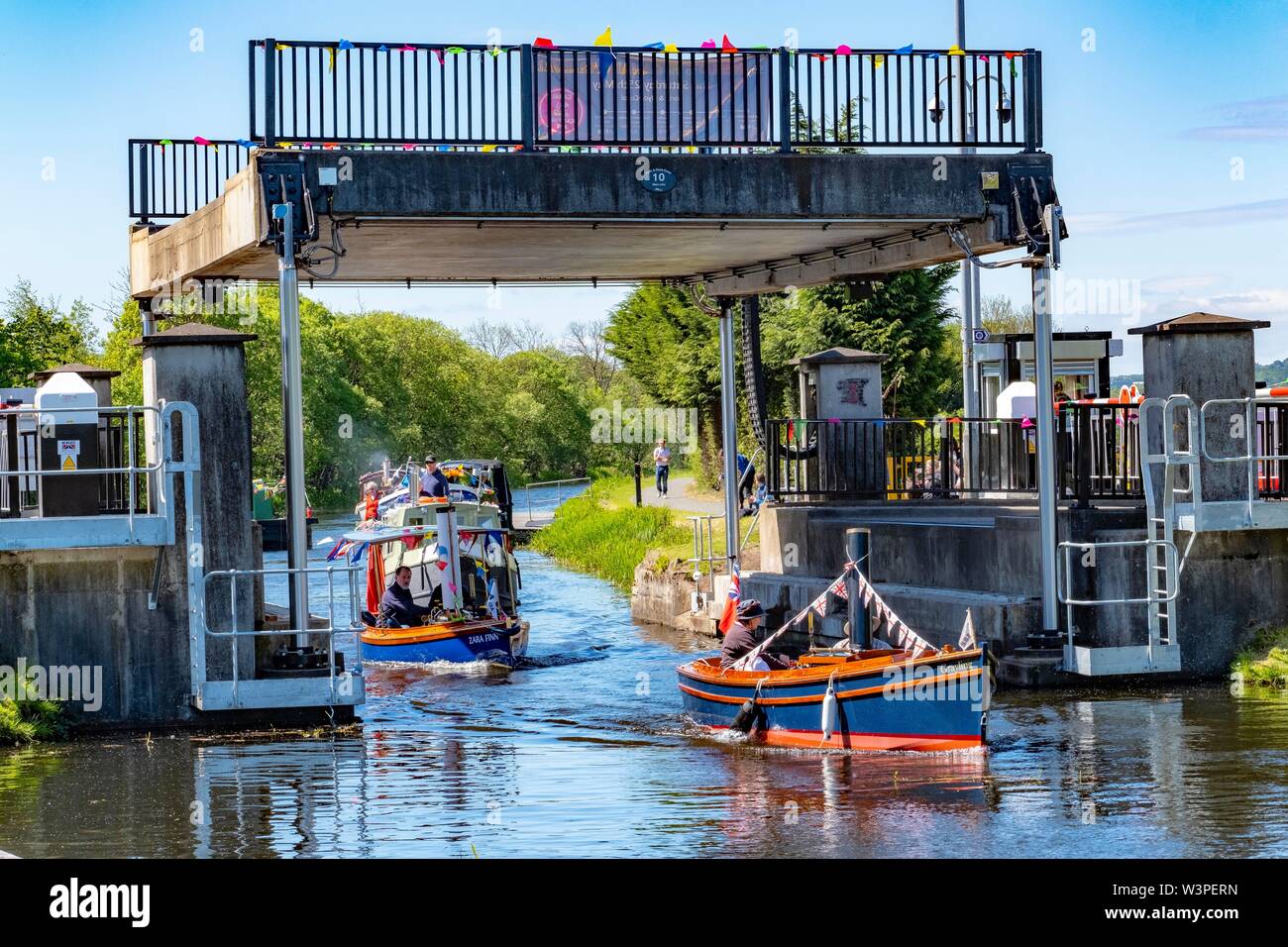 boats passing under a lift bridge on the Forth and Clyde canal Stock Photo