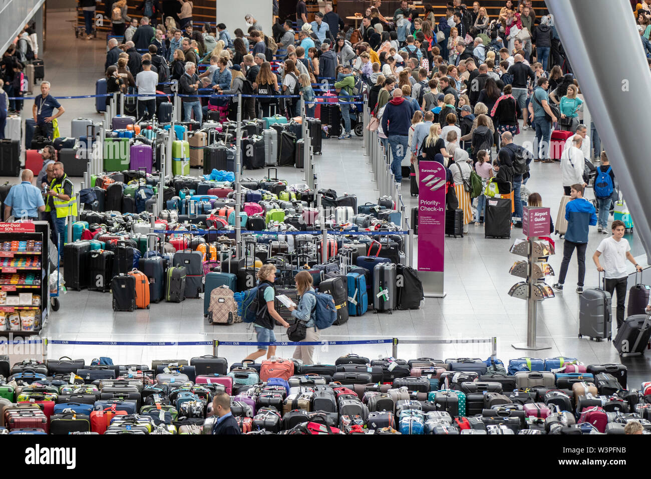 Duesseldorf, Germany. 17th July, 2019. Several hundred pieces of baggage  are standing in the departure hall of Düsseldorf Airport, blue ribbons with  the inscription Düsseldorf Airport DUS close off the area. Due