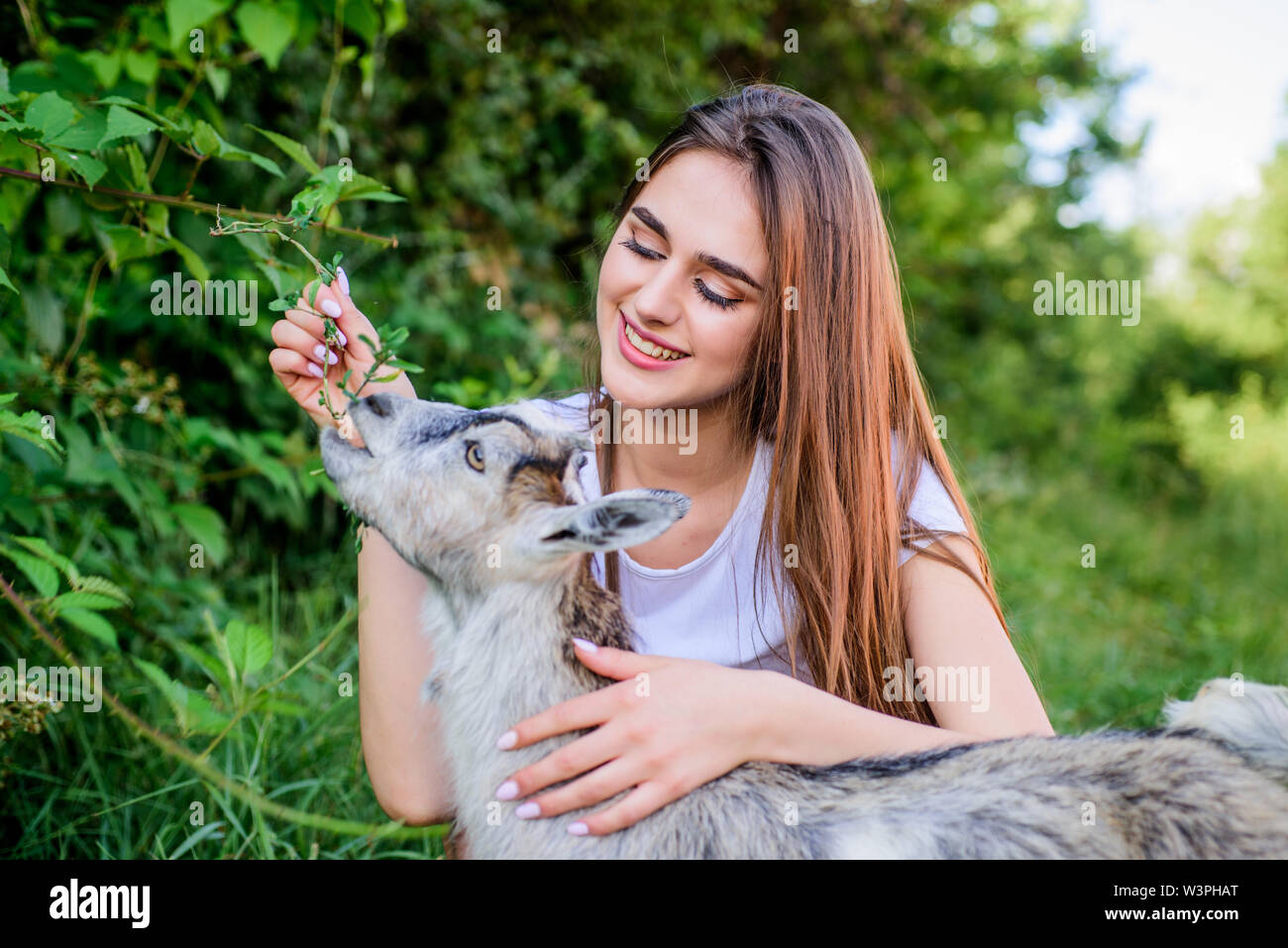 Hello pets. woman vet feeding goat. farm and farming concept. Animals are our friends. happy girl love goat. village weekend. summer day. Love and protect animals. contact zoo. veterinarian lamb goat Stock Hello pets. woman vet feeding goat. farm and farming concept. Animals are our friends. happy girl love goat. village weekend. summer day. Love and protect animals. contact zoo. veterinarian lamb goat Stock