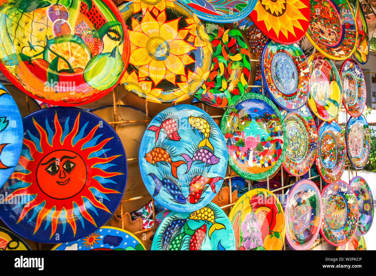 Colorful handmade decorative mexican plates with many patterns on the
