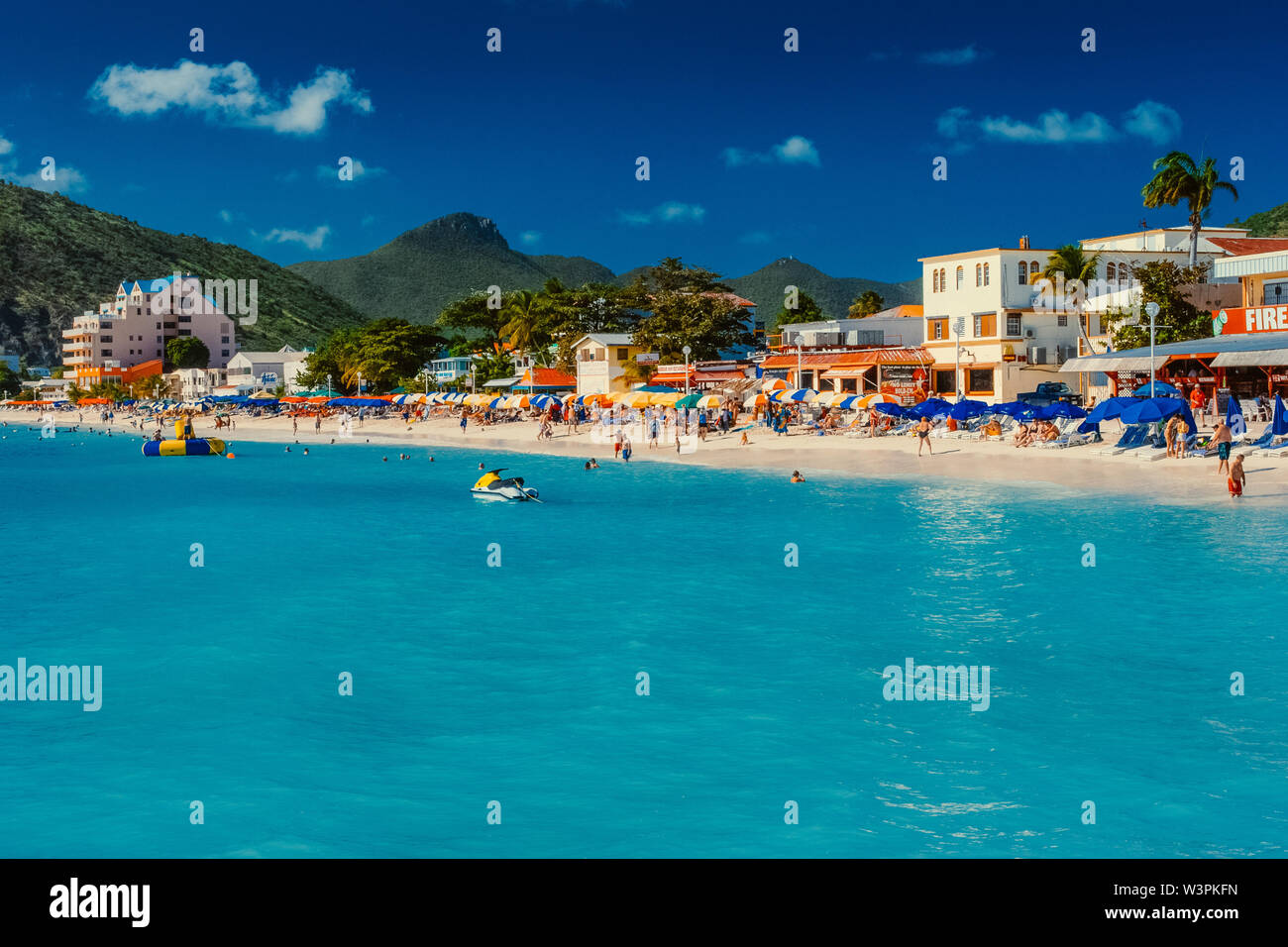 Sint Maarten / Caribbean / Netherlands - January 23.2008: Summer view on the sandy beach with people resting and swimming in the turquoise color sea. Stock Photo