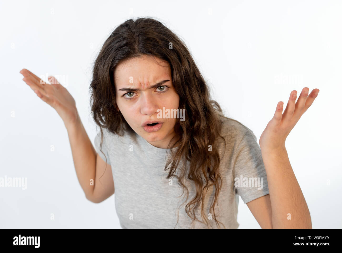 Close up portrait of a pretty young caucasian girl with an angry face.  Looking outraged and mad looking at the camera. Human facial expressions  and em Stock Photo - Alamy