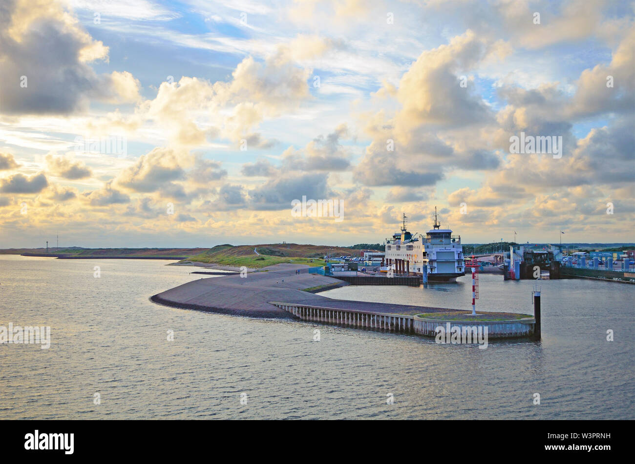 Large retired double ended passanger and car ferry by company TESO called 'Schulpengat' in harbor '’t Horntje' at sunset Stock Photo