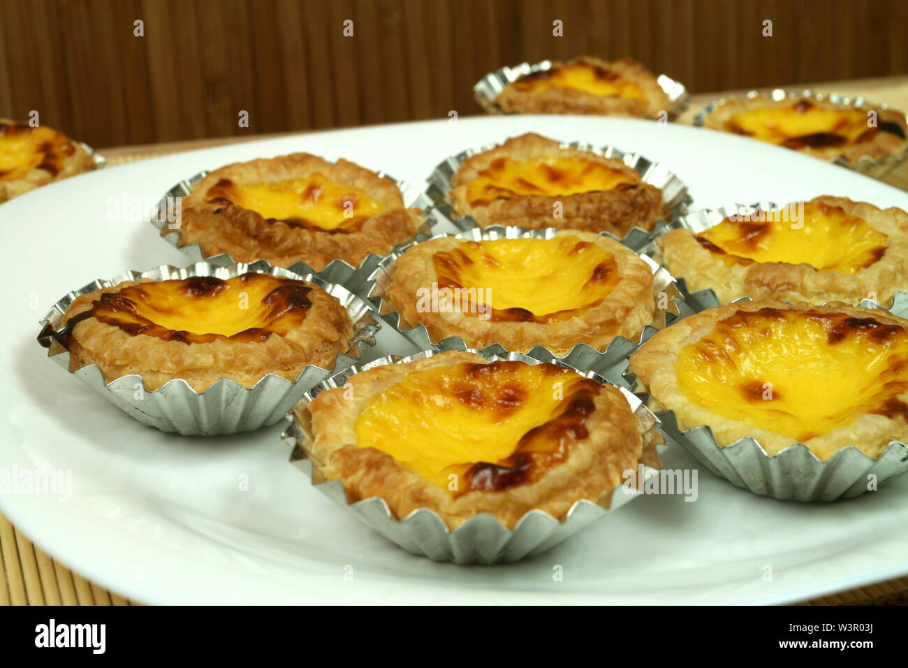 Traditional portuguese egg tarts 'pasteis de nata' in tin moulds on