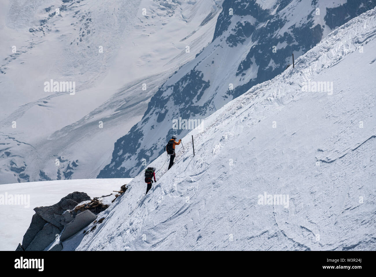 Alpinist returning to Aiguille du Midi on sunny summer day in Chamonix, France Stock Photo