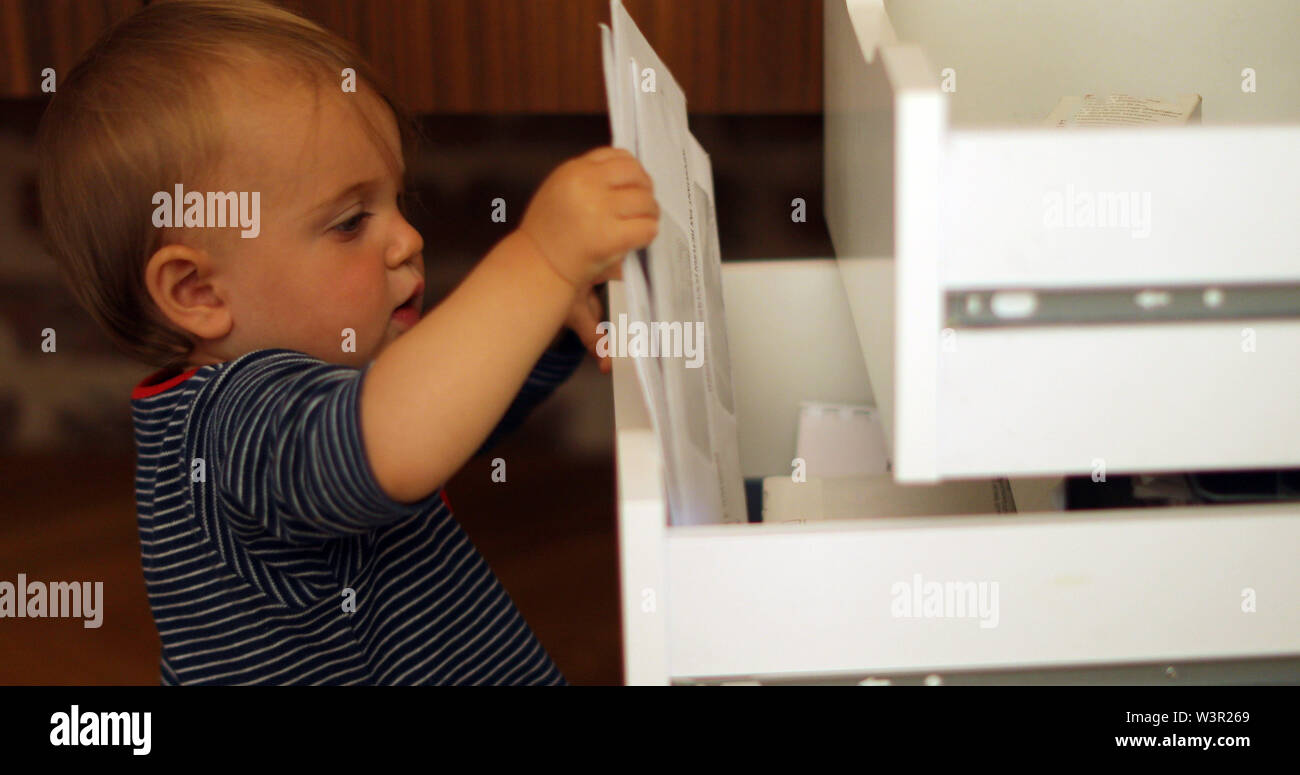 Child exploring open drawers Stock Photo Alamy
