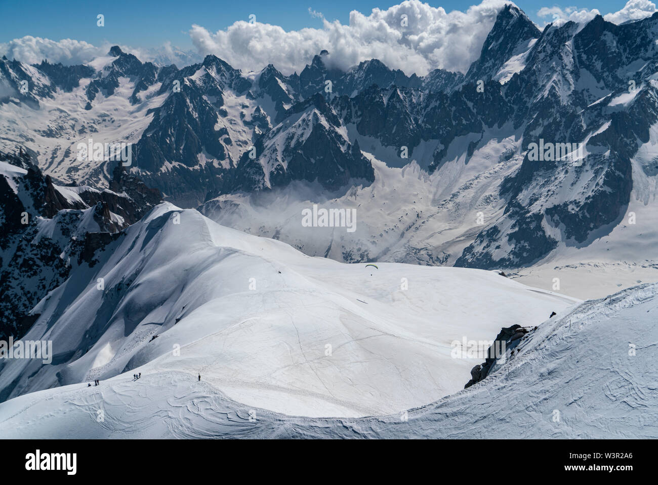 Alpine scenery with mountaineers down on a glacier Stock Photo