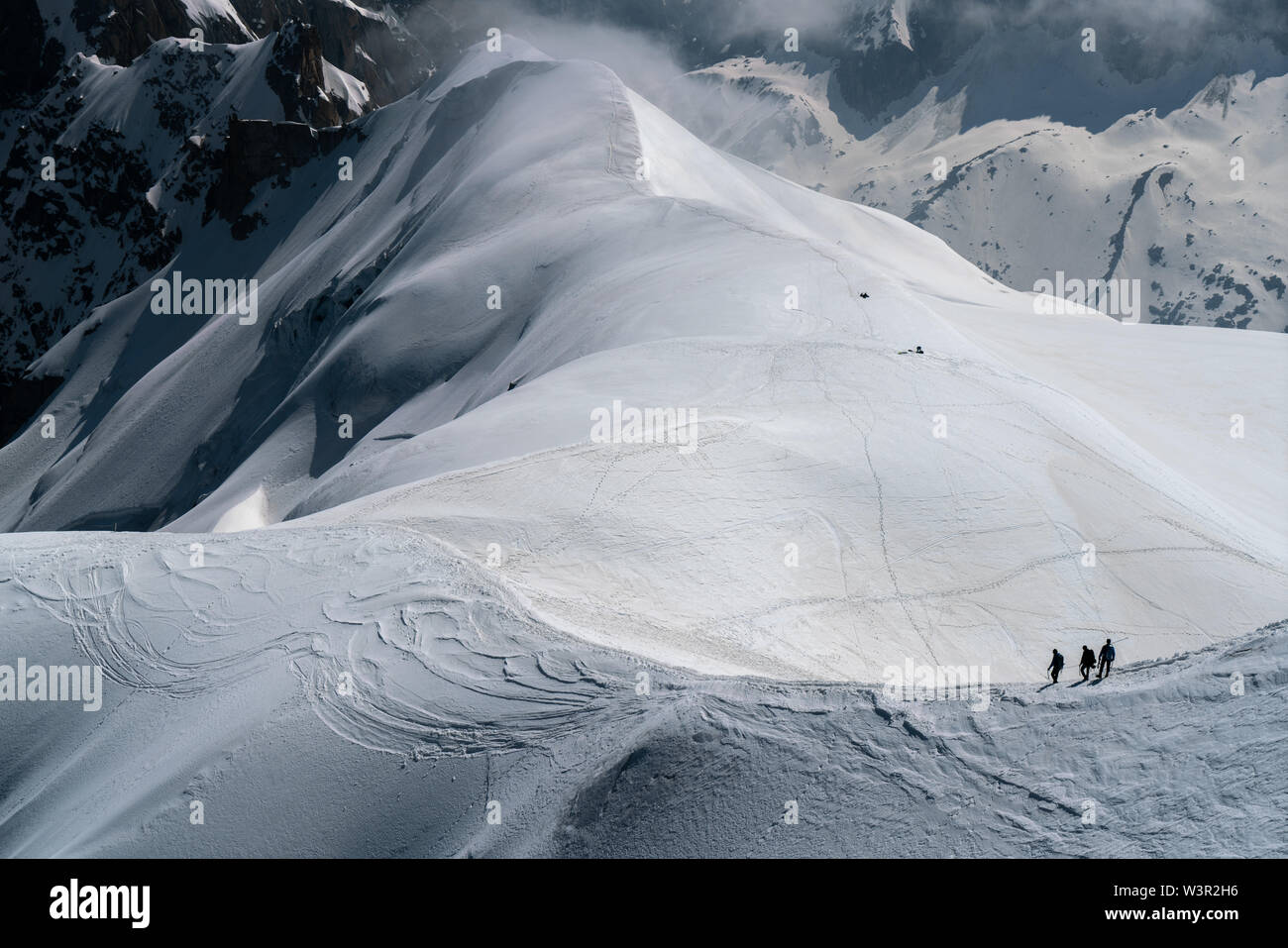 Mountaineers descending down to a glacier from Aiguille Du Midi in Chamonix, France Stock Photo