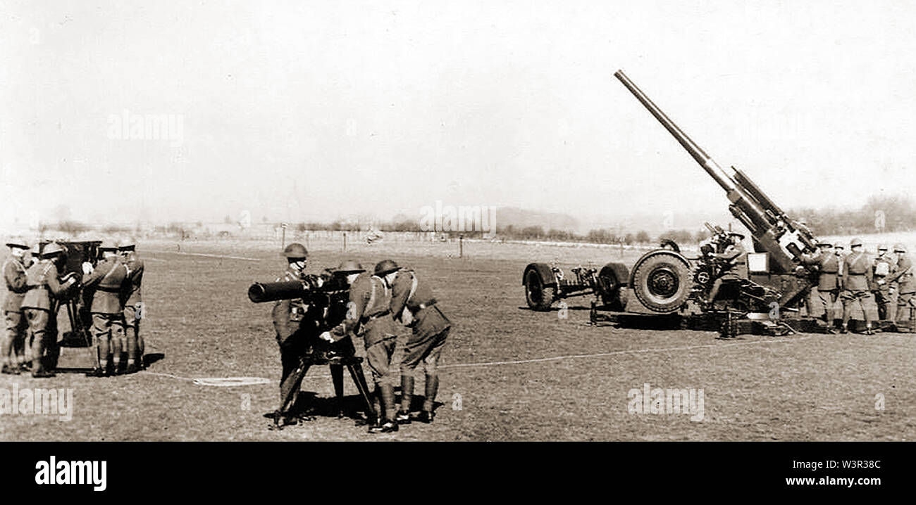 WWII postcard image showing UK weapons (A Predictor,Finder and an heavy AA gun) possibly taken during target practice Stock Photo