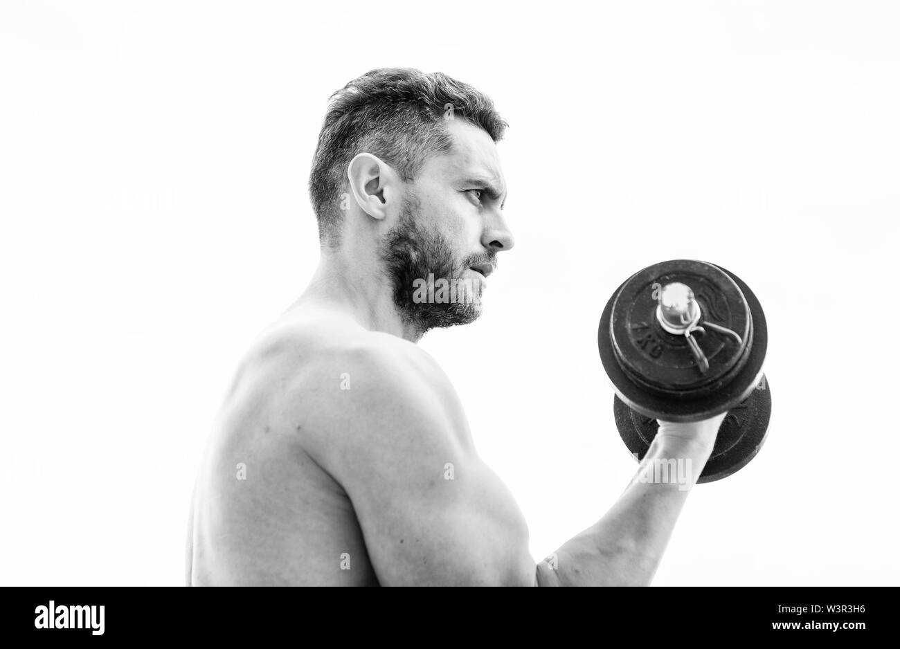 man sportsman with strong hands. steroids. athletic body. Dumbbell gym. fitness and sport