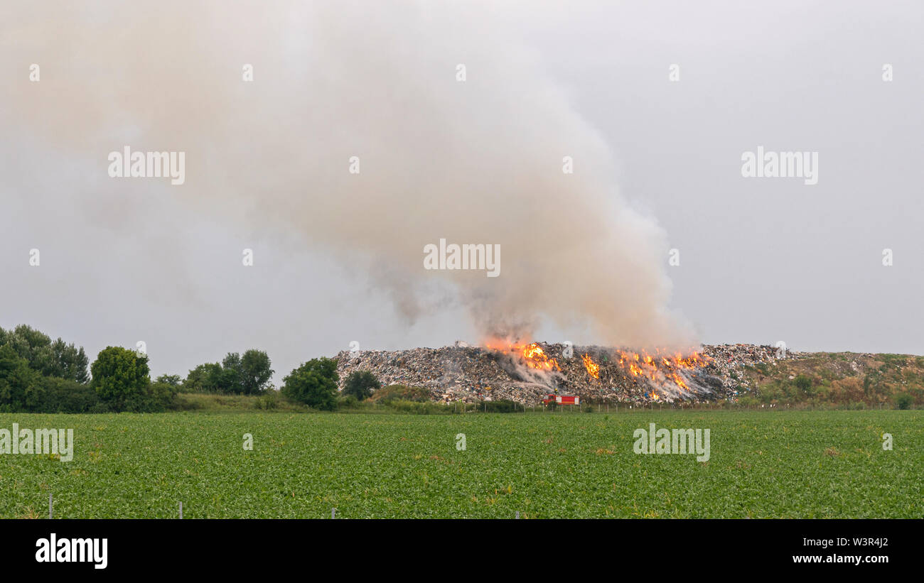 Simanovci, Serbia - June 13, 2018: Garbage Fire at Illegal Dumping Site Landfill Near Simanovci, Serbia. Stock Photo