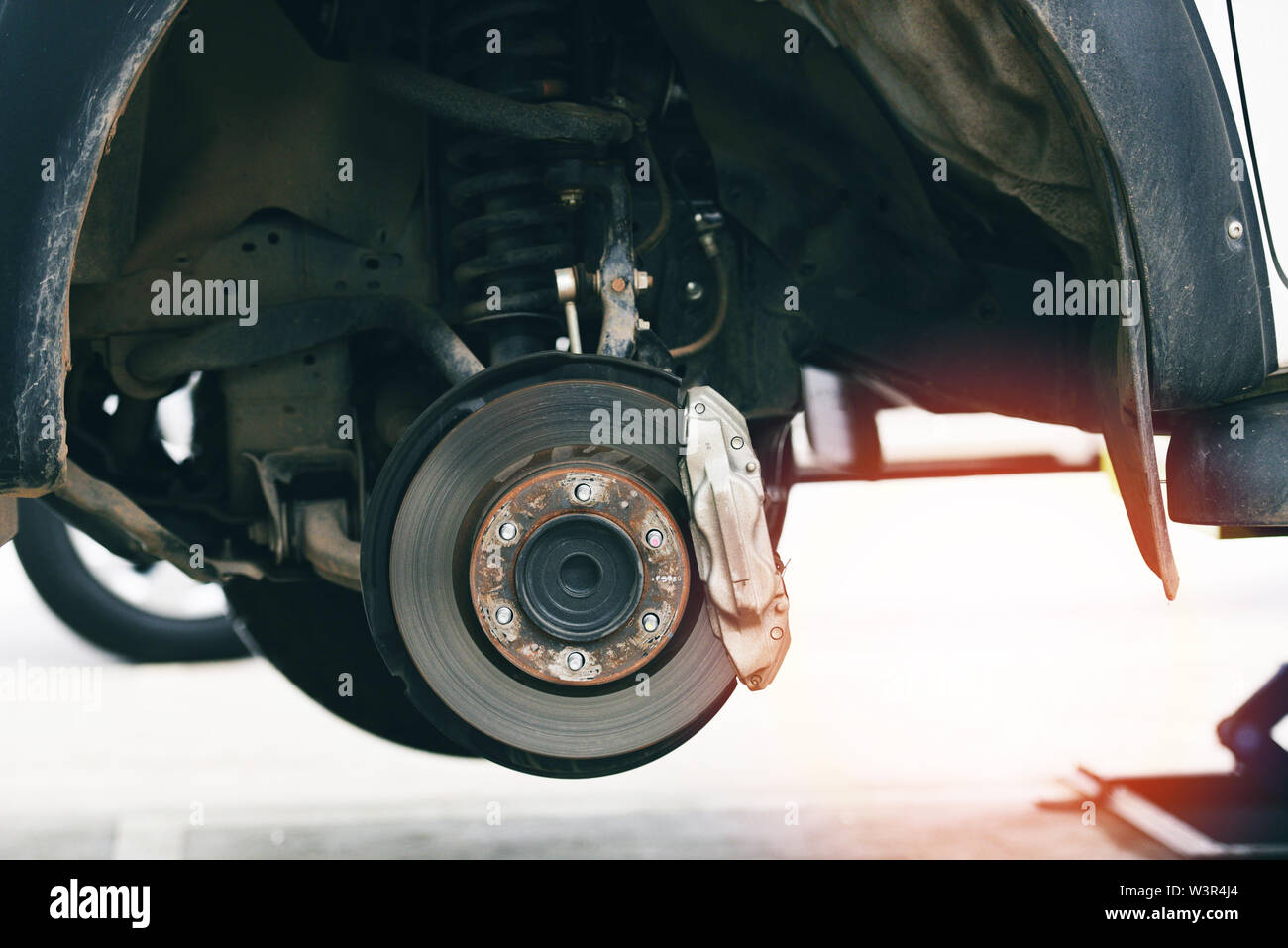 Disc brakes car part at garage / pickup car brake disc raised on lift
