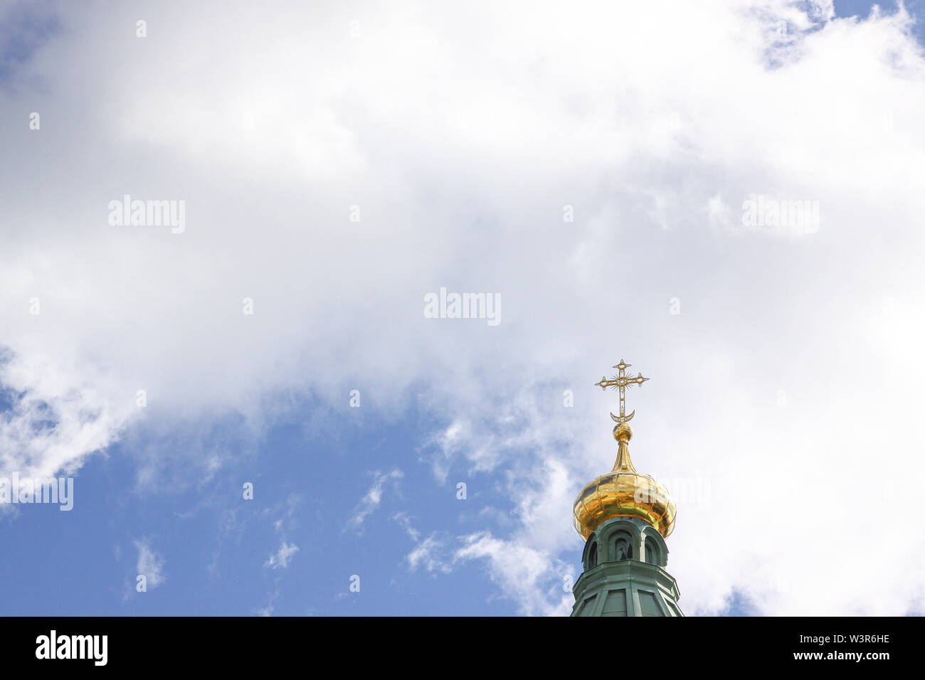 Golden onion dome with cross on top of Uspenski Cathedral in Helsinki Stock Photo