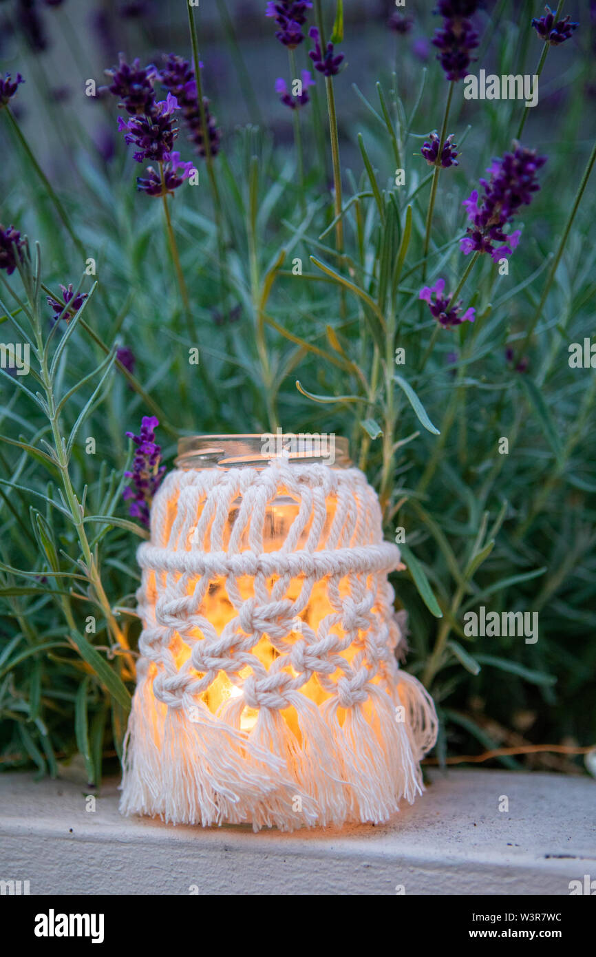 A macrame jam jar cover makes a light for outdoors UK Stock Photo