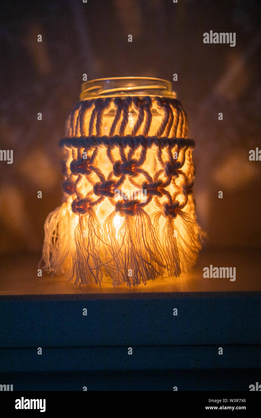 A macrame jam jar cover makes a light for indoors UK Stock Photo Alamy