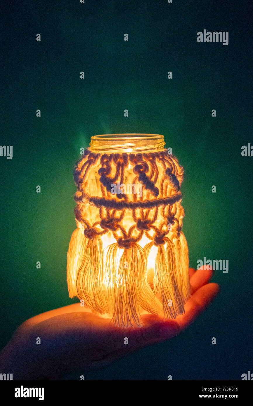 A macrame jam jar cover makes a light for indoors UK Stock Photo