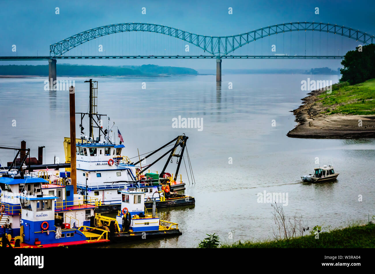 The Hernando de Soto Bridge, also called the M Bridge, is pictured with tug boats, Sept. 10, 2015, in Memphis, Tennessee. Stock Photo
