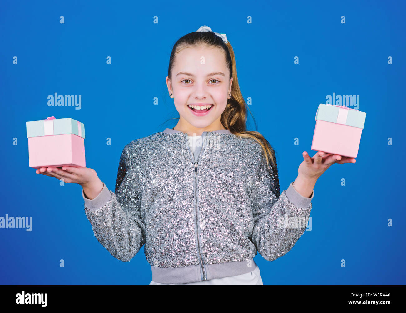 Pick bonus. Special happens every day. Girl with gift boxes blue background. Black friday. Shopping day. Cute child carry gift boxes. Surprise gift box. Birthday wish list. World of happiness. Stock Photo