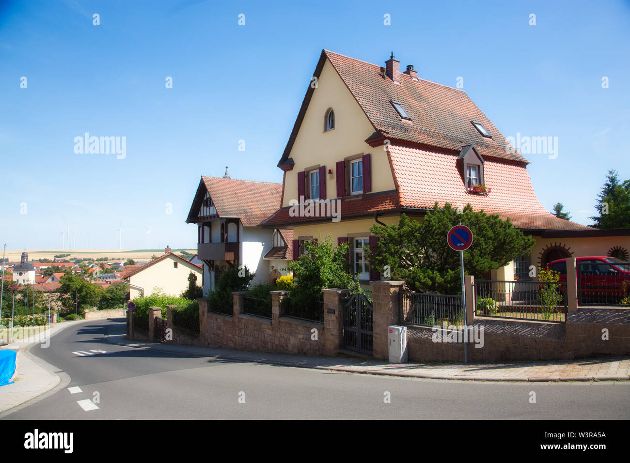 Real estate agent in front of residential villas hires stock