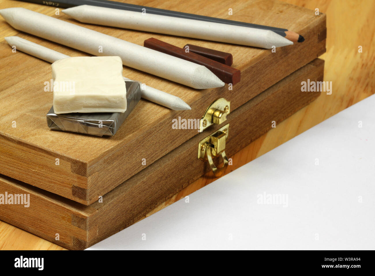 Drawing proffessional tools paper stumps,charcoal pencil and sticks on wooden box. Copyspace