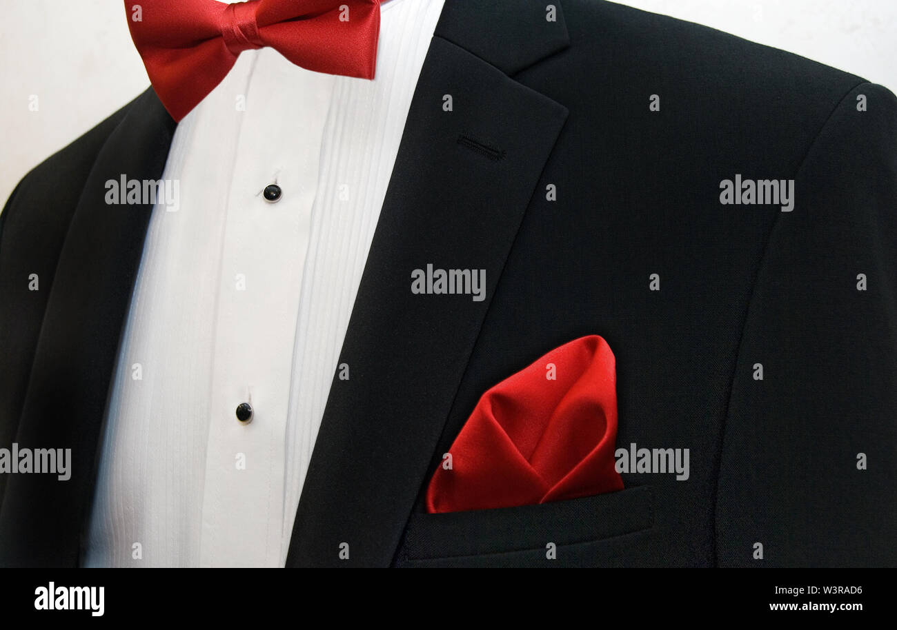 Red bow tie and handkerchief accenting black tuxedo with white shirt Stock Photo