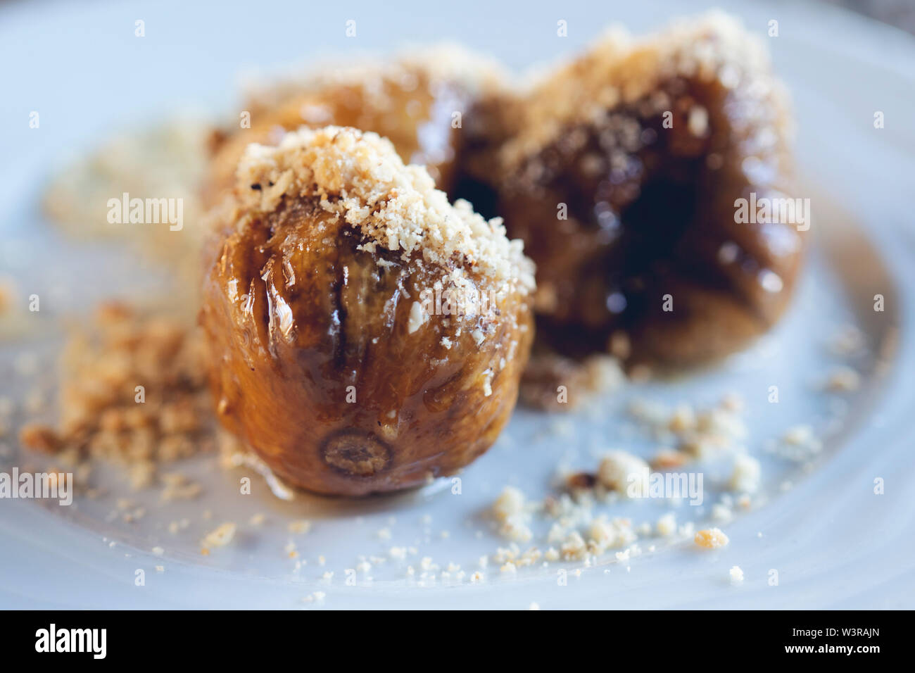 caramelized figs with walnut, served as a dessert, close up Stock Photo
