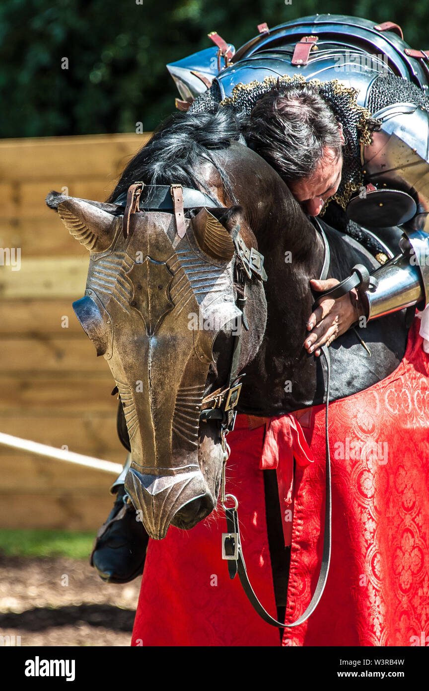 A knight hugs his horse during a historical re-enactment Joust week at Arundel Castle photo ©Julia Claxton Stock Photo