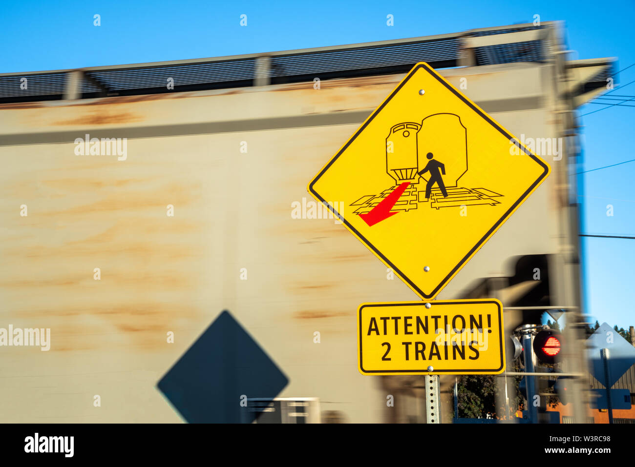 Warning sign for pedestrians at a railroad crossing. Concept of safety. Stock Photo