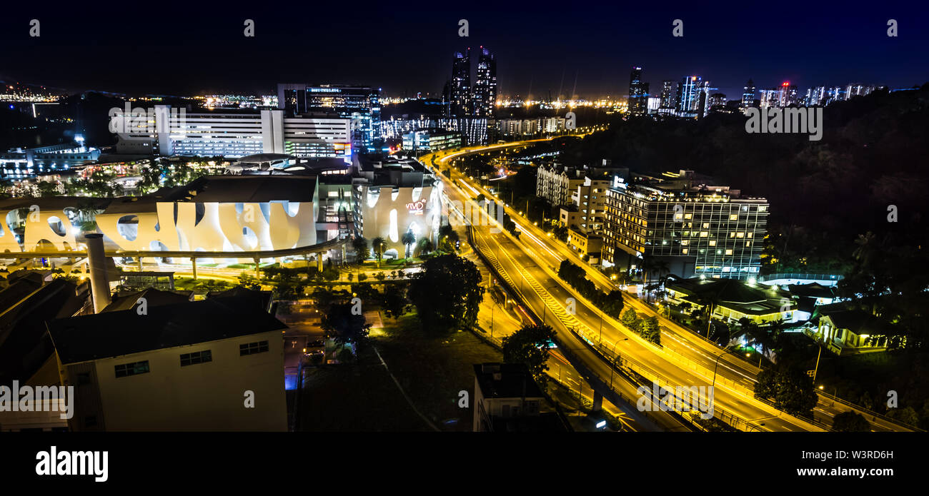Singapore - April 25, 2018: Beautiful aerial view of VivioCity, HourbourFront and West Coast Highway brightly lighted  at night. Stock Photo