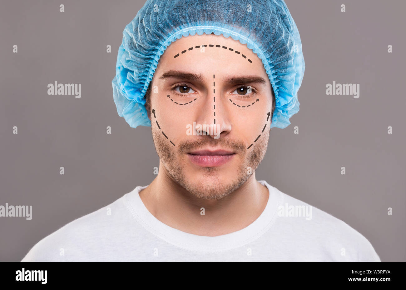 Handsome man in medical hat with pencil marks on skin Stock Photo Alamy