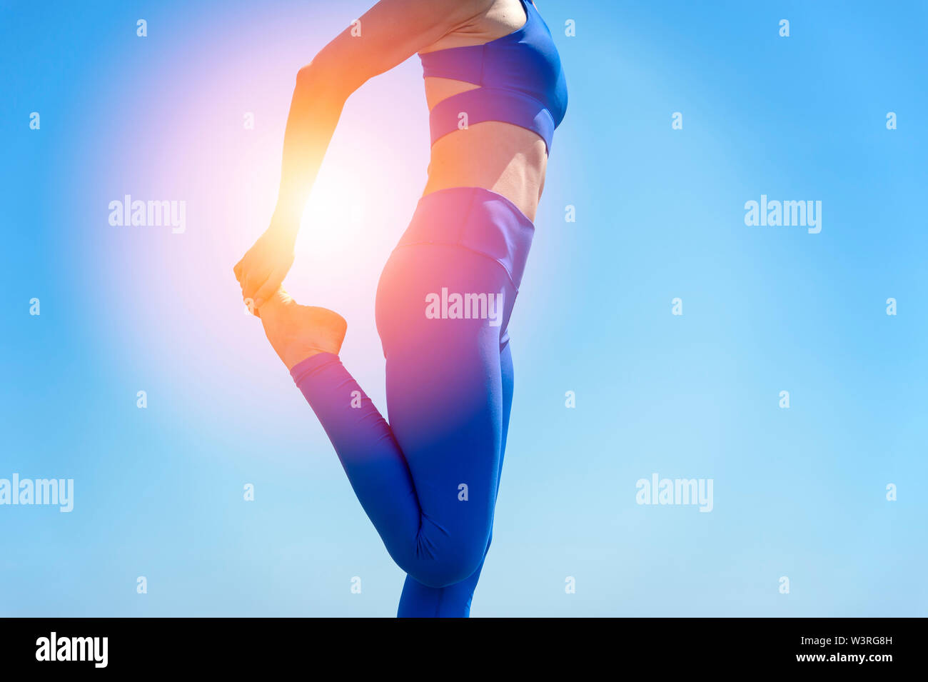 sporty woman doing a leg stretch, close up. Stock Photo
