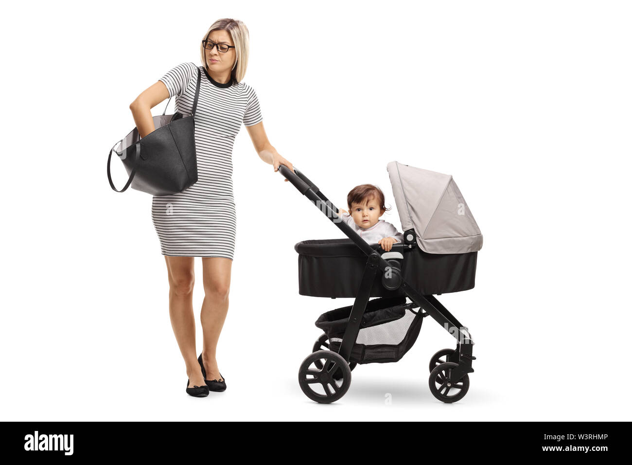 Full length portrait of a mother with a baby in a stroller searching a handbag isolated on white background Stock Photo