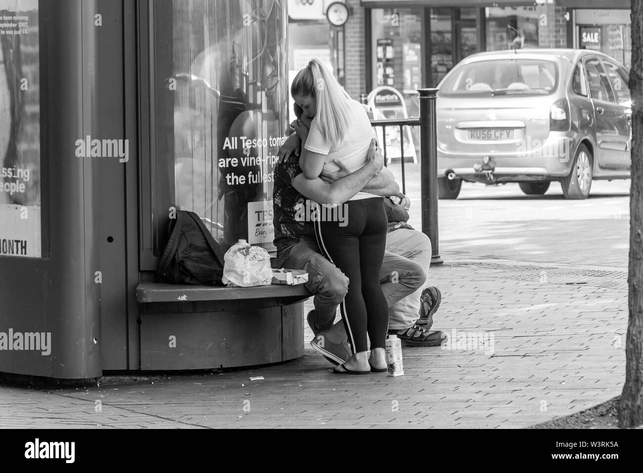 Young couple all over one another in Abington st, Northampton, uk. Stock Photo