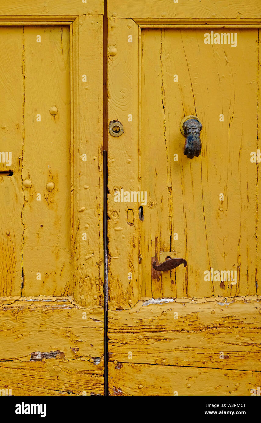 old weathered yellow painted door, lot valley, france Stock Photo