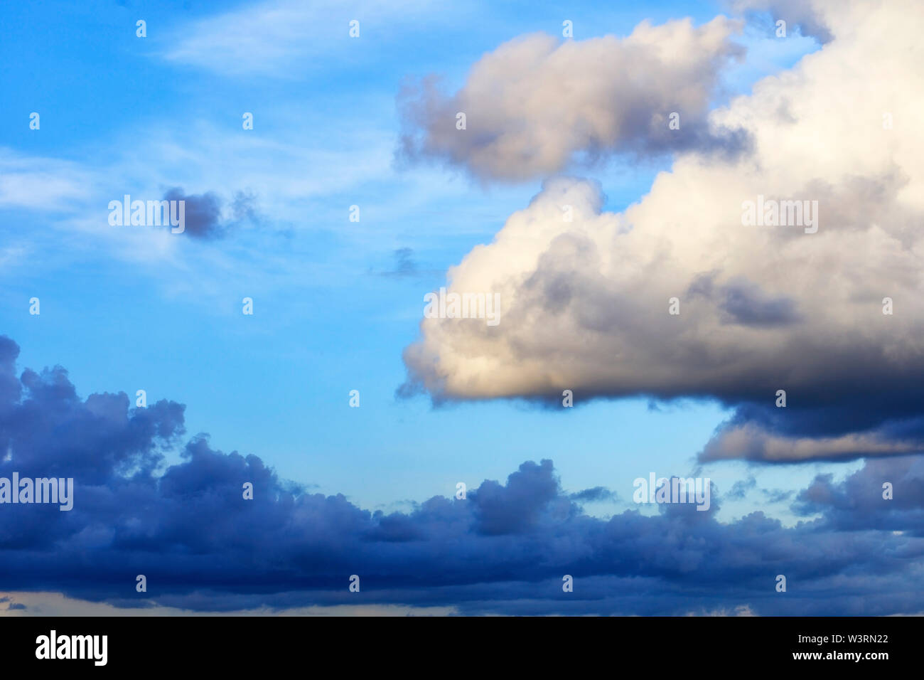 Thunderclouds float in the sky, gathering together. Stock Photo