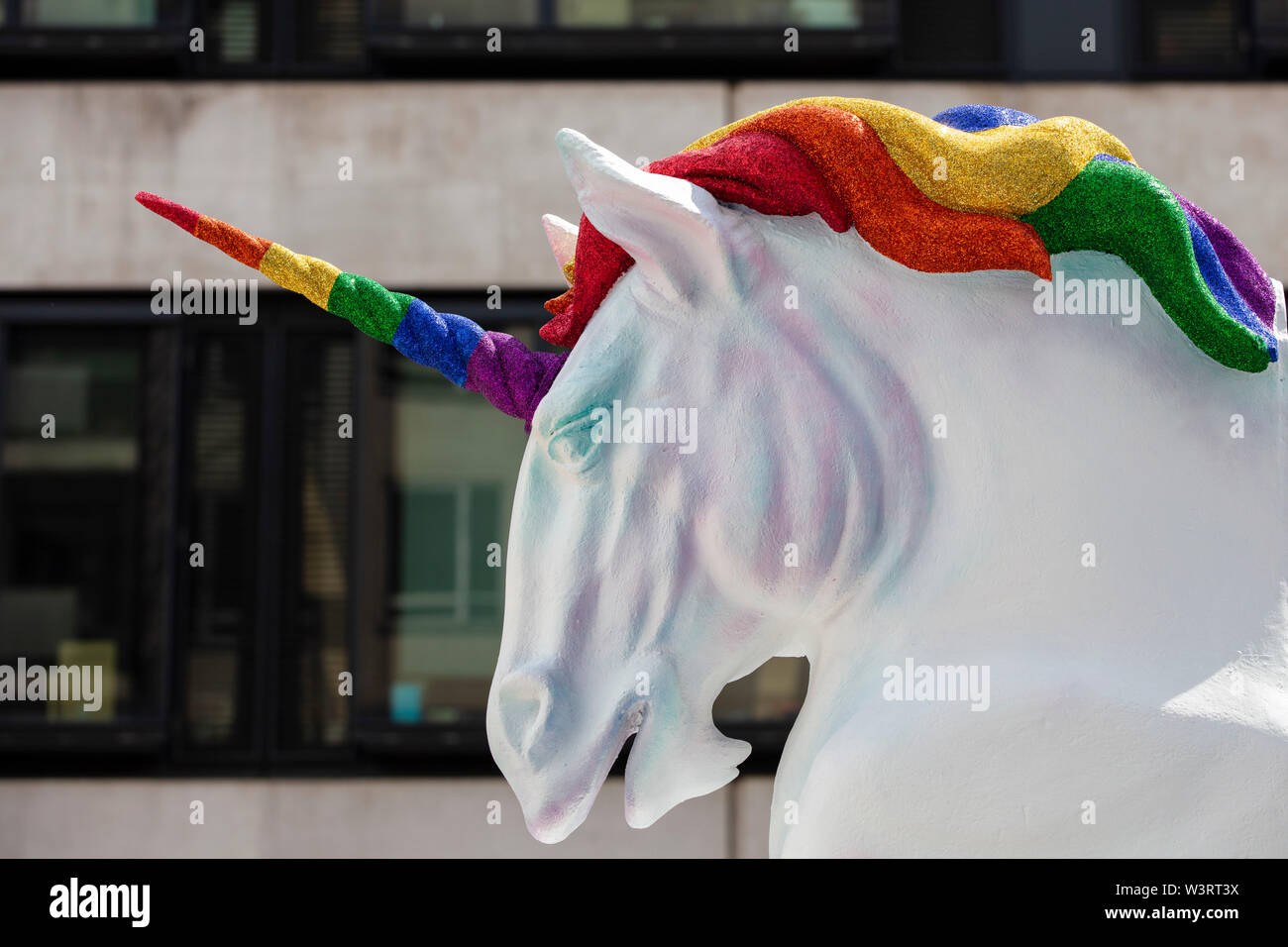 Fantasy white unicorn with colourful horn and mane Stock Photo