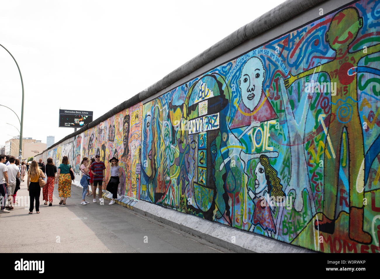 Street art on the former Berlin Wall forms the East Side Gallery on Muhlenstrasse in Berlin, Germany. Stock Photo