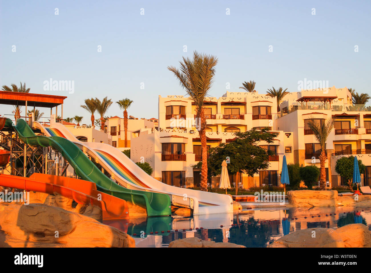 Water colorful rainbow slides with swimming pool in the hotel at dawn in Egypt. Water sport intertainment Stock Photo