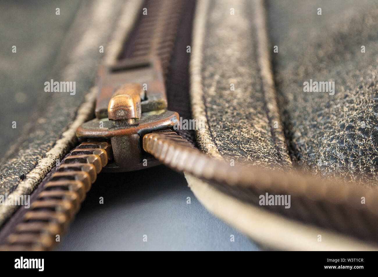 macro of zipper on light brown leather Stock Photo