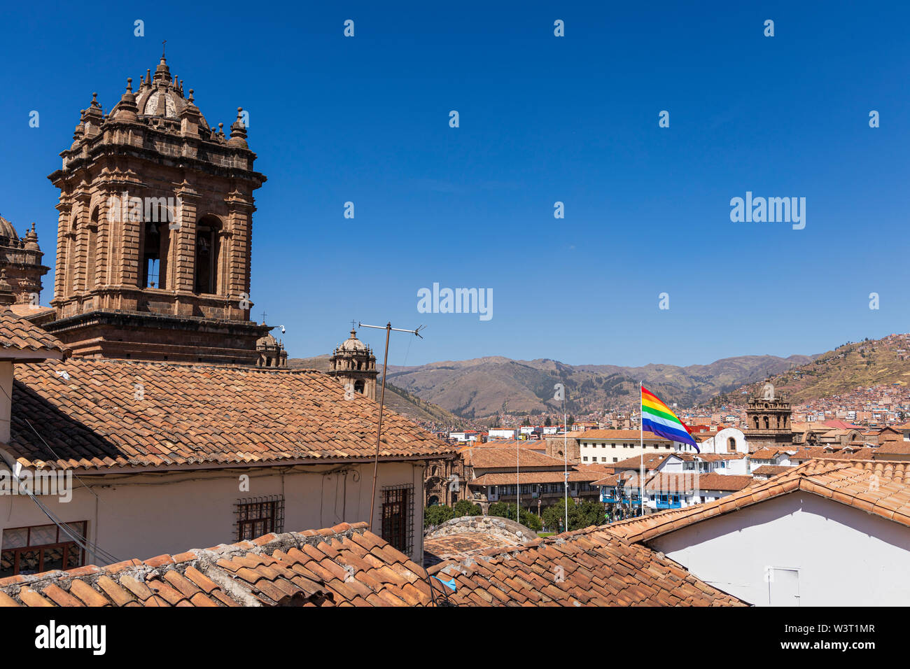 Cusco flag flying over the rooftops in the Plaza de Armas, Cusco, Peru, South America Stock Photo