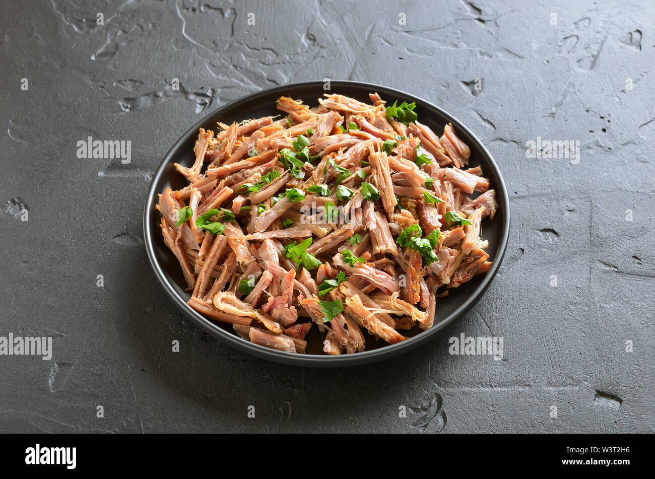 Slow cooked pulled pork for sandwiches on plate Stock Photo