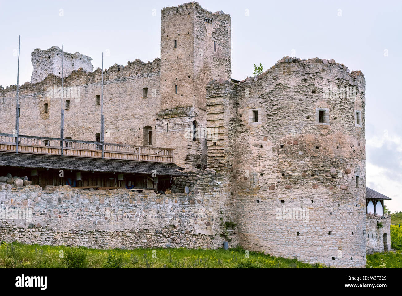 The ruins of the fortress bastion of the old castle against the gray sky. Stock Photo
