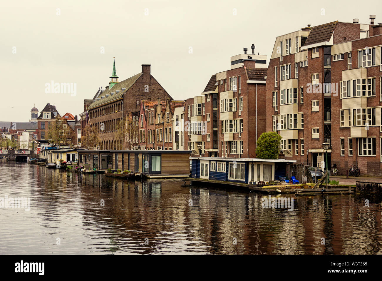 Leiden, Holland, Netherlands, April 18, 2019,  the old town of Leiden with historic barges and residential houses, yachts and houseboats Stock Photo