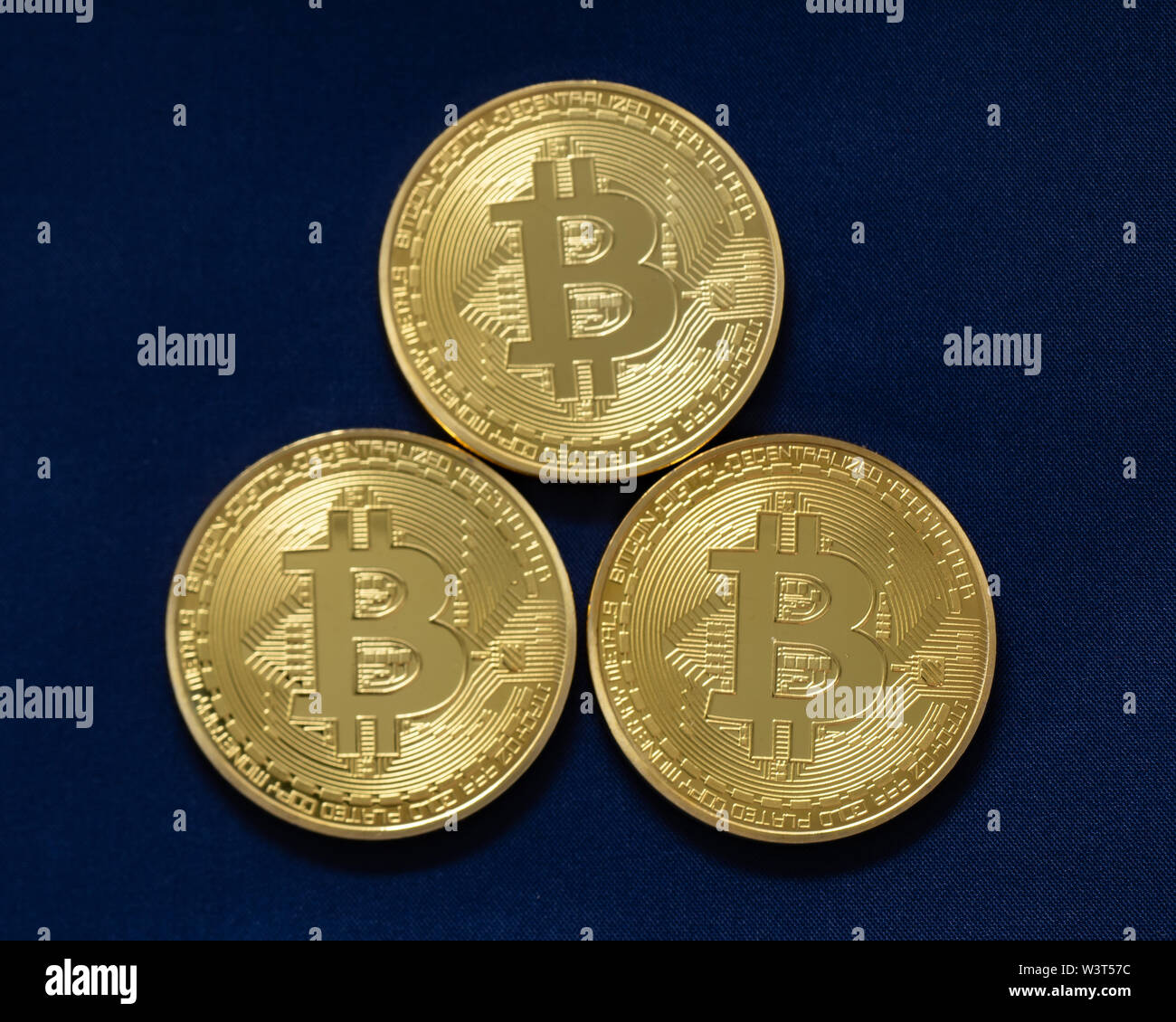 Three bitcoins, symbols for the cryptocurrency used on the internet. Stock Photo