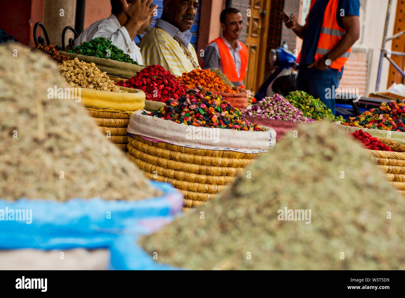 Local Moroccan stalls selling nuts, sweet goods in the streets, alleyways of Marrakech going about daily arabic life in the cultural Medina Stock Photo